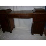 A 19th century figured mahogany sideboard, the twin pedestals with drawers and shelves enclosed by