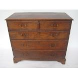 A George III oak chest of drawers, the t