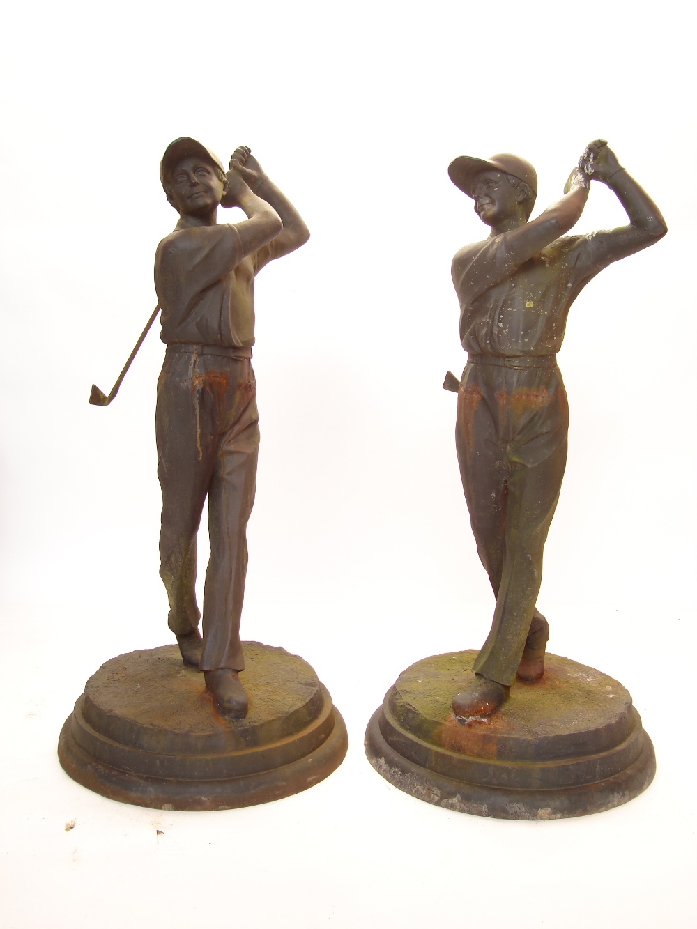 A pair of cast iron golfers on circular