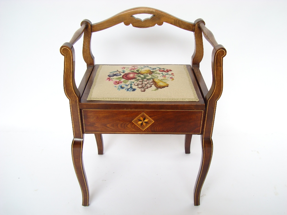 An Edwardian stained beech piano stool,