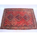 A Shiraz rug, red ground.  200 x 142cm.