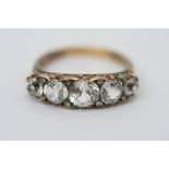 An Edwardian five stone half hoop diamon