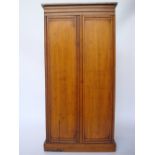 An Edwardian satinwood cupboard,