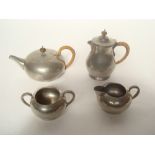 Liberty tudric pewter four piece Arts and Crafts four piece tea service, with hammered finish,