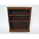 A Victorian oak open bookcase, the adjustable shelves with gilt tooled leather dust guards,