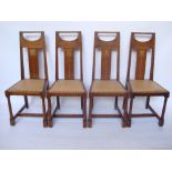 A set of four Arts and Crafts oak dining chairs designed by George Montague Ellwood (1875 - 1955)