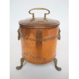 A late 19th Century copper and brass coal bin and cover, with lion mask ring handles,