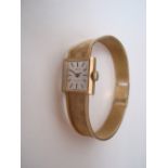 A ladies 9 carat gold Tissot strlist wristwatch, the rectangular silvered dial with baton markers,