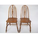 A pair of early 20th Century ash, elm and beech hoop and spindle back chairs,
