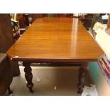 An Indian teak extending dining table,