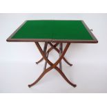 A late 19th Century mahogany coaching card table, the top inset with green baize, an X-frame base.