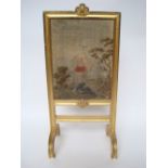 A late Victorian gilt gesso fire screen, with moulded frame,