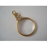An 18ct gold diamond set magnifying glass pendant,
