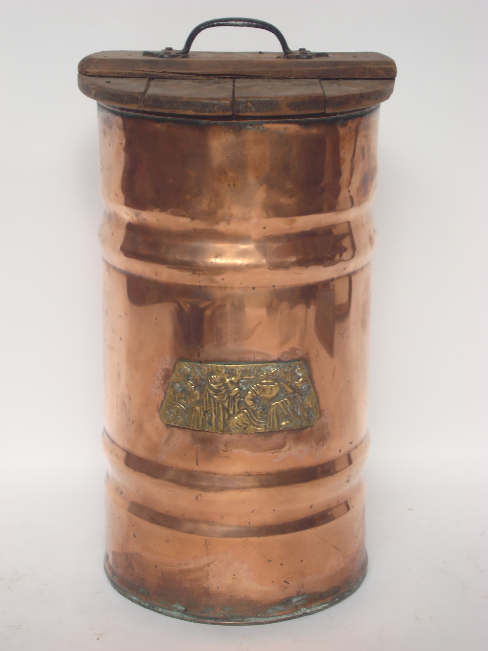 An early 20th Century large copper log bin with embossed brass plaque and wooden lid.