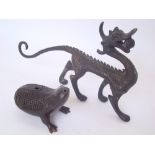 A Chinese bronze water dropper in the form of a three legged toad together with a freestanding