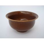 A small brown glazed Chinese porcelain bowl, six character Jiajing mark, 11cm diameter.