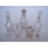 A pair of early 19th Century cut glass mallet shaped decanters with later stoppers together with