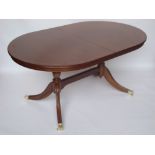 A Regency style extending reproduction mahogany twin pedestal dining table.