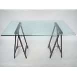 A Contemporary glass topped desk on black folding trestle supports.
140 x 83 x 77cm high.