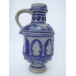 A 17th century German Westerwald salt glazed stoneware armorial jug.