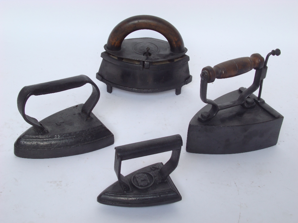 A late 19th Century J & J Siddons elliptical sleeve iron with wooden handle and trivet base,