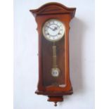 A mahogany Highlands wall clock with spring driven eight day striking movement.