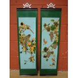 A pair of Chinese lacquer wall hanging panels, decorated with birds on fruiting branches.
