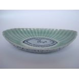 A large Japanese ovoid fluted celadon glazed fluted dish, poss late Edo,