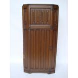 A mid 20th Century oak single door wardrobe with fitted interior.