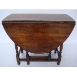 An 18th Century style oval oak gateleg table.