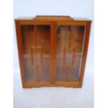 An Art Deco Indian teak glazed display cabinet.