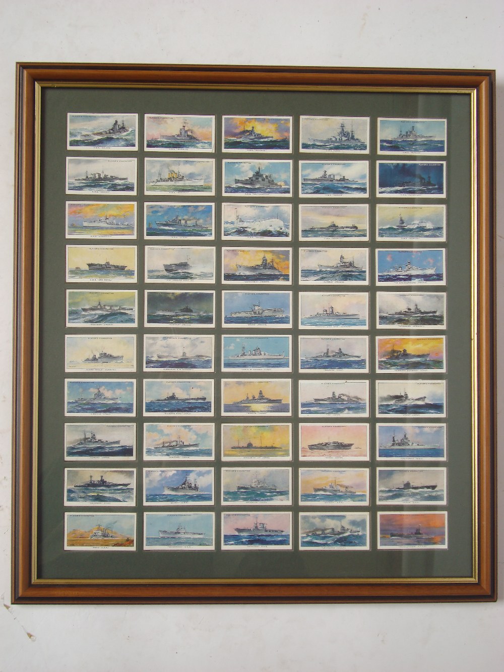 A framed set of John Player Modern Naval Craft cigarette cards.
