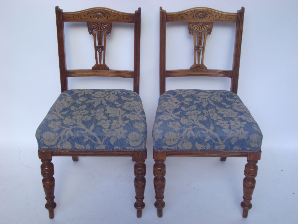 A pair of Edwardian walnut side chairs.