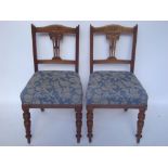A pair of Edwardian walnut side chairs.