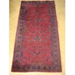 A Persian floral curvilinear design carpet, areas of wear.
157 x 305cm.