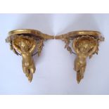 A pair of 19th Century Continental carved giltwood and gesso wall brackets,