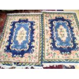 A pair of Chinese blue ground wool rugs with carved pile.