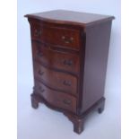 Reproduction George III style serpentine small chest of drawers, on bracket feet.