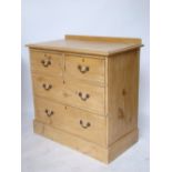 An Edwardian small pine chest of drawers, with two short and two graduated long drawers,