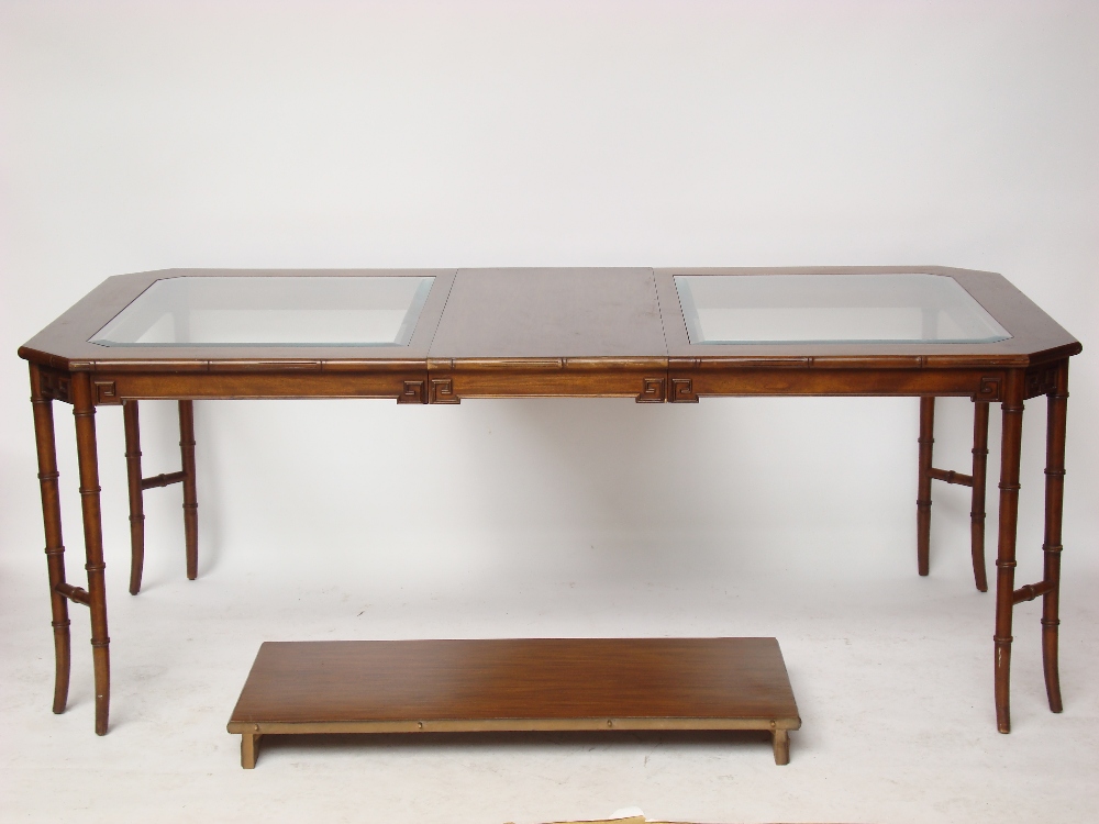 A reproduction mahogany extending dining table,