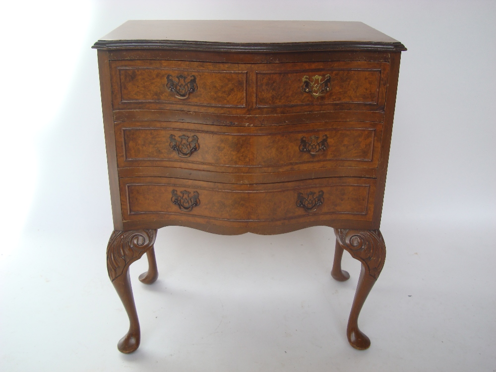 A burr walnut serpentine small chest of drawers, with drawers on cabriole legs.