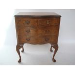 A burr walnut serpentine small chest of drawers, with drawers on cabriole legs.