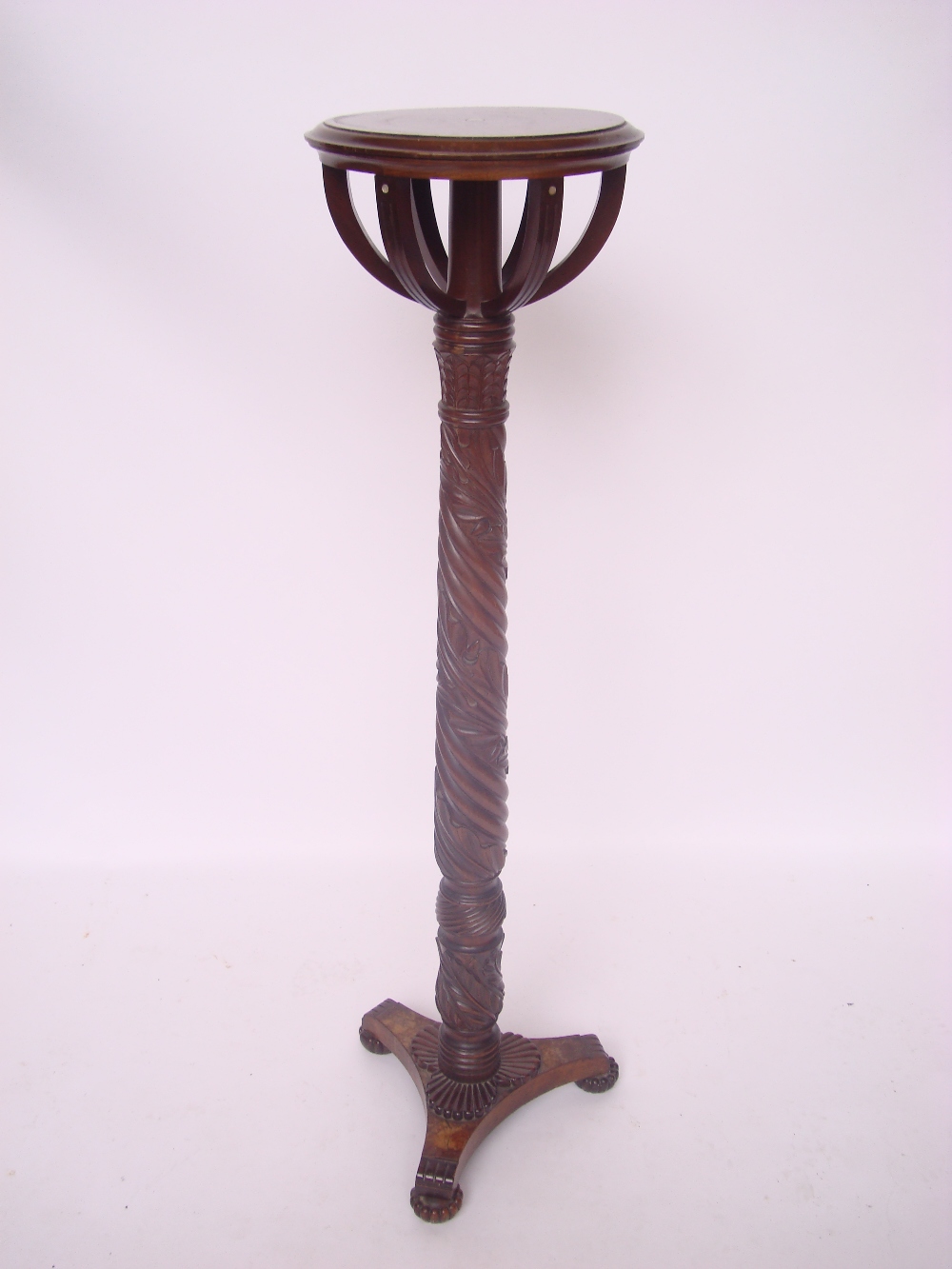 A hardwood torchere, with spiral twist stem carved with acorns and oak leaves.