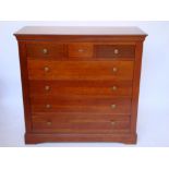 A French cherry wood chest of drawers with secretaire drawer.