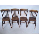A set of four late 19th Century beech, ash and elm spindle back kitchen chairs.