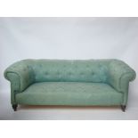 A late Victorian buttonback upholstered Chesterfield sofa, with rollover back and arms,