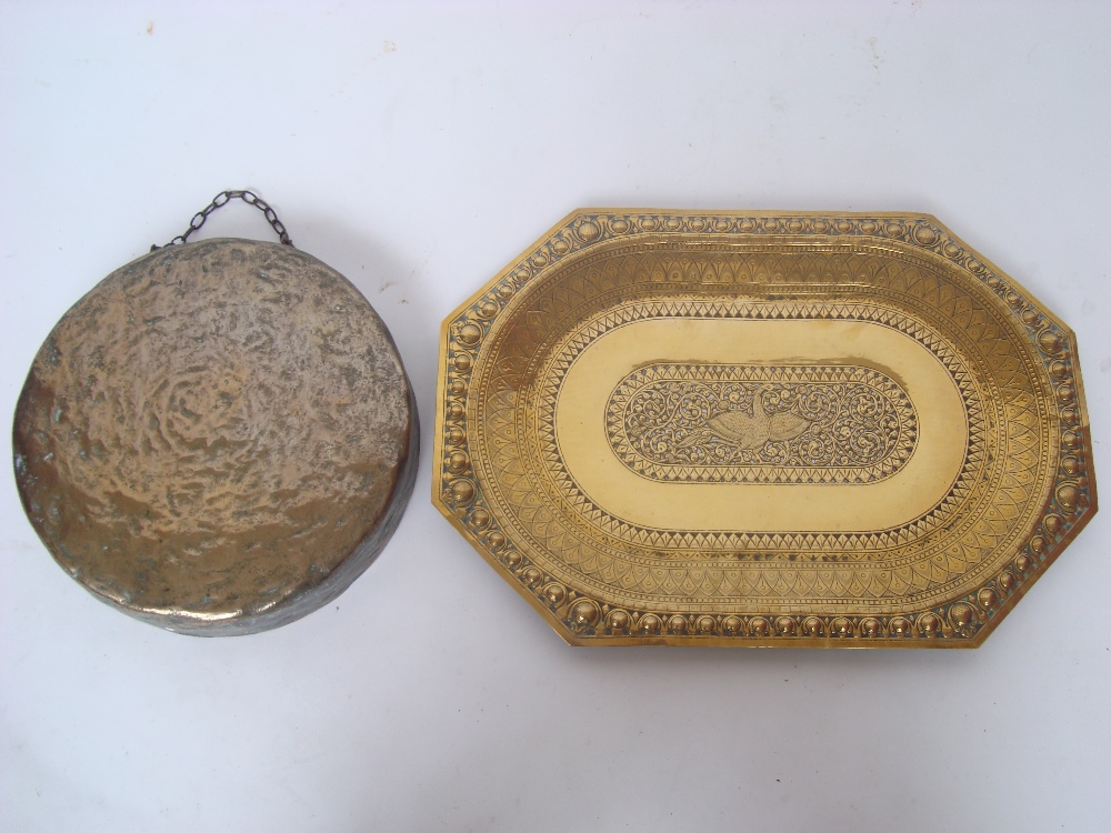 A 19th Century Indian pierced brass tray with chased and embossed decoration and a copper dinner