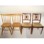 A pair of beech stick back kitchen chairs together with a pair of reproduction mahogany dining