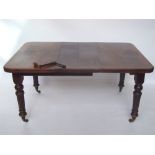 A late Victorian mahogany extending dining table, the top with moulded edge and rounded corners,