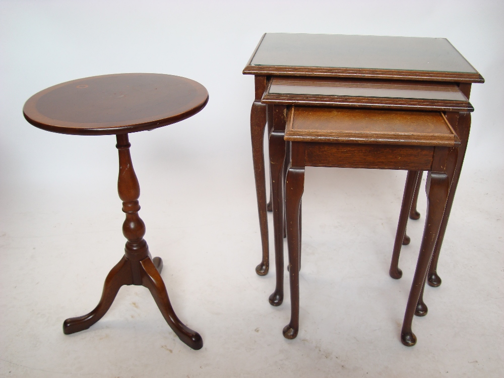 A reproduction mahogany nesting trio of occasional tables and a reproduction low tripod table (2).